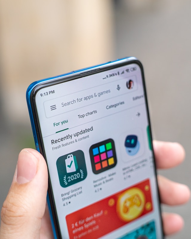 Suggested photo: shop owner holding a phone with their app on screen