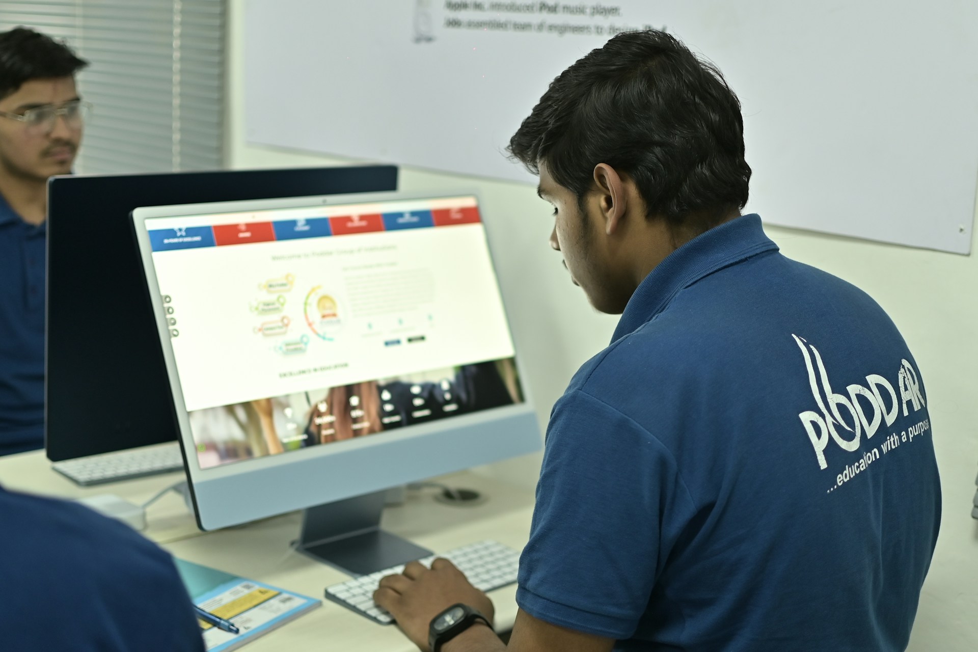 Someone in a uniform using a computer